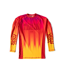 While They Tan rashguard, front — heat-haze gradient from magenta at the shoulders to yellow at the hem, TRAIN in seventies poster lettering across the chest.